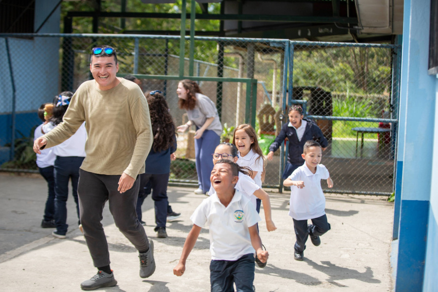 Baylor students playing with elementary school children on a mission trip