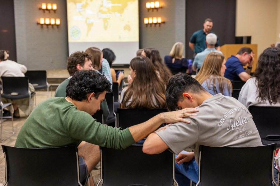 Students praying at the Mission Trip Commissioning